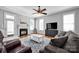 Cozy living room features a fireplace, ceiling fan, and comfortable seating arrangement at 15430 Waterfront Dr, Huntersville, NC 28078