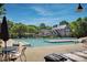 Expansive community pool with surrounding chairs and a view of the clubhouse and beautiful landscaping at 15430 Waterfront Dr, Huntersville, NC 28078