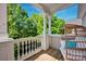 Relaxing covered porch with a swinging chair and views of mature trees at 15430 Waterfront Dr, Huntersville, NC 28078