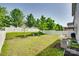 Spacious backyard with a white picket fence, a fire pit, and a small patio at 1553 Arcadia Bluff Dr, York, SC 29745
