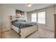 Bedroom with two large windows, a Queen bed with a padded headboard, and carpeted floors at 1553 Arcadia Bluff Dr, York, SC 29745