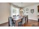 The bright dining room features hardwood floors, a stylish chandelier, and large windows at 1553 Arcadia Bluff Dr, York, SC 29745