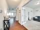 Hallway with hardwood floors leading to a carpeted room with white trim and a view of the staircase at 1553 Arcadia Bluff Dr, York, SC 29745