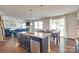 Bright kitchen island with granite counters overlooks a living area with hardwood floors and dining room at 1553 Arcadia Bluff Dr, York, SC 29745