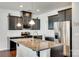 Modern kitchen with stainless steel appliances, granite countertops, and dark cabinetry at 1553 Arcadia Bluff Dr, York, SC 29745