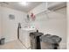 Functional laundry room with white washer and dryer, tile floors, and shelving at 1553 Arcadia Bluff Dr, York, SC 29745
