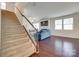A staircase leads up from the living room, which features hardwood floors and a blue sofa at 1553 Arcadia Bluff Dr, York, SC 29745