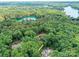 Picturesque aerial view of a house nestled in a verdant forest near a tranquil lake at 167 Greenbay Rd, Mooresville, NC 28117
