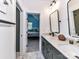 Bathroom showcases double vanity, marble floor, and open view to a blue bedroom suite at 167 Greenbay Rd, Mooresville, NC 28117