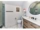 Bathroom with a toilet, shower, round mirror, modern sink, and neutral decor at 167 Greenbay Rd, Mooresville, NC 28117