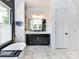 Bright bathroom features a soaking tub, black cabinets, and modern fixtures, creating a spa-like retreat at 167 Greenbay Rd, Mooresville, NC 28117