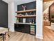 The dining area features custom cabinetry, shelving, a beverage fridge, and stone countertops at 167 Greenbay Rd, Mooresville, NC 28117