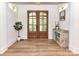 Entryway with wood-look floors, double doors, a decorative cabinet, and modern sconces at 167 Greenbay Rd, Mooresville, NC 28117