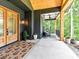 Inviting front porch with seating, exterior ceiling fan, and decorative outdoor rug near the front door at 167 Greenbay Rd, Mooresville, NC 28117