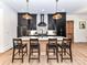 Modern kitchen island features stone countertops, pendant lighting, and seating at 167 Greenbay Rd, Mooresville, NC 28117