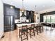 Modern kitchen boasts stone countertops, stainless steel appliances, and an island with seating at 167 Greenbay Rd, Mooresville, NC 28117