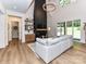 Open-concept living room with fireplace, high ceilings, hardwood floors, and natural light at 167 Greenbay Rd, Mooresville, NC 28117