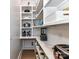 Well-organized pantry with white shelving, marble countertop, and ample storage space for appliances and food items at 167 Greenbay Rd, Mooresville, NC 28117