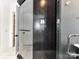 Modern shower with black herringbone tile, glass enclosure, and sleek fixtures for a spa-like experience at 167 Greenbay Rd, Mooresville, NC 28117