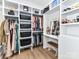 Spacious walk-in closet with custom shelving, hanging rods, and a vanity area for organized storage at 167 Greenbay Rd, Mooresville, NC 28117