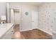 Inviting bedroom featuring hardwood floors, a white dresser, and a door to hall for added privacy at 1813 Shelbourne Way, Fort Mill, SC 29707