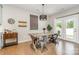 Cozy dining area with a rustic wooden table, modern lighting, and access to the outdoor patio at 1813 Shelbourne Way, Fort Mill, SC 29707