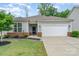 Charming single-story home with a two-car garage, manicured lawn, and brick accents at 1813 Shelbourne Way, Fort Mill, SC 29707
