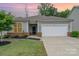 Charming single-story home with a two-car garage, manicured lawn, and brick accents at dusk at 1813 Shelbourne Way, Fort Mill, SC 29707