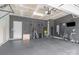 Spacious garage equipped with gym setup on the black rubber floor perfect for fitness enthusiasts at 1813 Shelbourne Way, Fort Mill, SC 29707