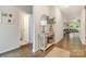 Inviting hallway with hardwood floors, stylish console table, and a glimpse into the living area at 1813 Shelbourne Way, Fort Mill, SC 29707
