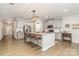 Bright, spacious kitchen features stainless appliances, gray cabinets, and large island with bar stool seating at 1813 Shelbourne Way, Fort Mill, SC 29707