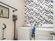 Convenient laundry area with modern washer, dryer, and stylish geometric wallpaper for added visual appeal at 1813 Shelbourne Way, Fort Mill, SC 29707