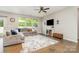 Comfortable living room featuring a plush sectional sofa, modern decor, and natural light at 1813 Shelbourne Way, Fort Mill, SC 29707