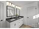 This bathroom features double sinks, granite countertops, and black fixtures at 2004 Waxhaw Crossing Dr, Waxhaw, NC 28173