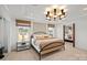 This bedroom features a unique chandelier, two windows, and a large mirror at 2004 Waxhaw Crossing Dr, Waxhaw, NC 28173