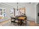 Formal dining room with a stylish chandelier, shiplap accent wall and a large window at 2004 Waxhaw Crossing Dr, Waxhaw, NC 28173