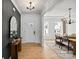 Bright entryway with hardwood floors, a stylish mirror, and an open view to the dining area at 2004 Waxhaw Crossing Dr, Waxhaw, NC 28173
