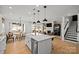 Expansive kitchen island with a view of the dining and living area, plus stairs to the second floor at 2004 Waxhaw Crossing Dr, Waxhaw, NC 28173