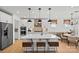 Spacious kitchen featuring a large island with seating, modern appliances, and stylish pendant lighting at 2004 Waxhaw Crossing Dr, Waxhaw, NC 28173