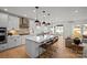 Open-concept kitchen with a center island, stainless steel appliances, and seamless flow into the living area at 2004 Waxhaw Crossing Dr, Waxhaw, NC 28173