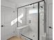 This modern shower features marble walls, a glass door, and a built-in bench at 2004 Waxhaw Crossing Dr, Waxhaw, NC 28173