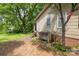 View of backyard with lush greenery, mature trees, and home's exterior at 208 N School St, Mount Gilead, NC 27306