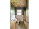 Bathroom with fixtures and tiled walls shows signs of damage, presenting an opportunity for remodeling at 208 N School St, Mount Gilead, NC 27306
