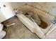 A close-up of the tub area in the bathroom reveals stains and worn fixtures ready for renovation at 208 N School St, Mount Gilead, NC 27306
