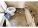 Bathroom fixtures, including a toilet and tub, show signs of age, making it ideal for renovation at 208 N School St, Mount Gilead, NC 27306