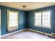 This bedroom has blue walls, a window with curtains, and hardwood floors at 208 N School St, Mount Gilead, NC 27306