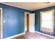 This bedroom includes a window with curtains, a closet, and hardwood floors at 208 N School St, Mount Gilead, NC 27306