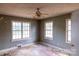 This bedroom features multiple windows, a ceiling fan, and a large open layout at 208 N School St, Mount Gilead, NC 27306