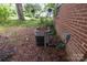 Exterior shot of home's HVAC unit on a bed of pine needles at 208 N School St, Mount Gilead, NC 27306