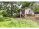 Exterior view of back porch and yard showing siding and greenery at 208 N School St, Mount Gilead, NC 27306